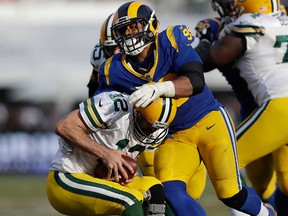 Los Angeles Rams defensive tackle Aaron Donald, above, sacks Green Bay Packers quarterback Aaron Rodgers, below, during the second half of an NFL game, Sunday, Oct. 28, 2018, in Los Angeles.