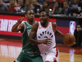 Raptors' Kawhi Leonard goes inside on Boston Celtics' Al Horford on Friday night.