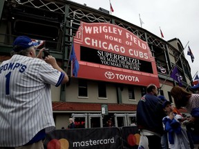 Chicago Cubs fans wait outside Wrigley Field before the National League wild-card playoff game against the Colorado Rockies Tuesday, Oct. 2, 2018, in Chicago.