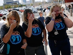 From left, Linda Hazelwood, Michelle Hamel and Jann Blake, all from California, cry as they attend a prayer service on the anniversary of the Oct. 1, 2017 mass shooting, Monday, Oct. 1, 2018, in Las Vegas.