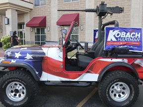 In this Aug. 7, 2018 file photo, a jeep with a replica machine gun mounted on back sits outside the hotel where Kansas Secretary of State Kris Kobach's supporters were meeting in Topeka, Kan.
