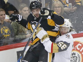 Pittsburgh Penguins' Justin Schultz, left, and Vegas Golden Knights' Erik Haula collide along the boards Thursday, Oct. 11, 2018, in Pittsburgh. (AP Photo/Keith Srakocic)