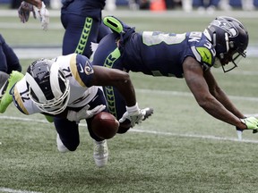 Los Angeles Rams wide receiver Brandin Cooks is hit by Seattle Seahawks free safety Tedric Thompson, right, during the first half of an NFL football game, Sunday, Oct. 7, 2018, in Seattle. Cooks left the game with an injury after the play.