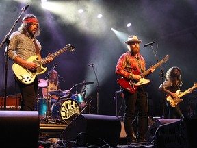 Leot Hanson (L), Sam Corbett (2ndFL), Ewan Currie (2ndFR),  and Ryan Gullen (R) of The Sheepdogs, perform during the Ottawa Folk Fest held at Hog's Back Park, on Sept. 7, 2012, in Ottawa.