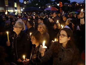 People hold candles as they gather for a vigil in the aftermath of a deadly shooting at the Tree of Life Congregation, in the Squirrel Hill neighborhood of Pittsburgh, Saturday, Oct. 27, 2018.