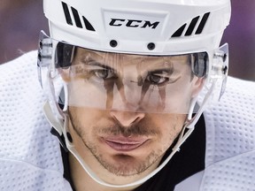 Pittsburgh Penguins' Sidney Crosby lines up for a faceoff as Vancouver Canucks' Brandon Sutter is reflected in his visor in Vancouver, on Saturday October 27, 2018. (THE CANADIAN PRESS/Darryl Dyck)