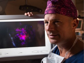 Dr. John Sinclair has been trained on a new brain surgery technique, used for first time in Canada, that makes malignant brain tumours glow in fluorescent pink and orange. Photo by Wayne Cuddington/ Postmedia