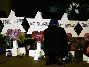 Stars of David with the names of those killed in a deadly shooting at the Tree of Life Synagogue stand in front of the synagogue in Pittsburgh, Sunday, Oct. 28, 2018.