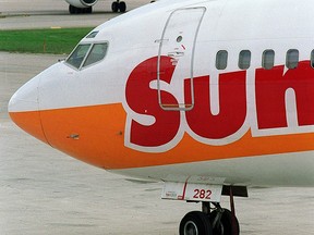 A jet with Sun Country Airlines taxis near airliners with Northwest. (Postmedia file photo)