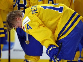 Sweden forward Elias Pettersson (14) reacts to the team's loss to Canada in the gold medal game of the world junior hockey championship, Friday, Jan. 5, 2018, in Buffalo, N.Y. (AP Photo/Jeffrey T. Barnes)