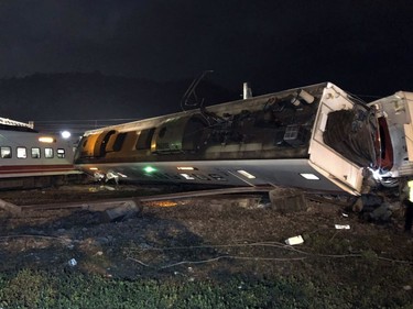In this photo released by Taiwan Railways Administration, train carriages are scattered at the site of a train derailment in Lian in northern Taiwan on Sunday, Oct. 21, 2018.