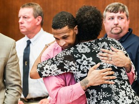 Quinton Tellis and defence attorney Darla Palmer hug after the judge declared a mistrial during the seventh day of Tellis' retrial of Monday, Oct. 1, 2018, in Batesville, Miss.