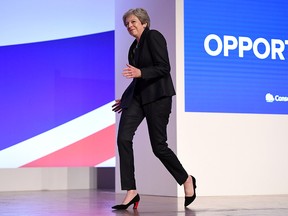 British Prime Minister Theresa May dances as she walks out onto the stage to deliver her leader's speech during the final day of the Conservative Party Conference at The International Convention Centre on October 3, 2018 in Birmingham, England. (Jeff J Mitchell/Getty Images)