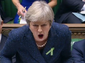 A video grab from footage broadcast by the U.K. Parliament's Parliamentary Recording Unit (PRU) shows Britain's Prime Minister Theresa May answering a question during the weekly question and answer session in the House of Commons in London on October 10, 2018. (HO/AFP/Getty Images)