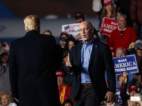 Rep. Greg Gianforte, R-Mont., is greeted on stage by President Donald Trump during a campaign rally at Minuteman Aviation Hangar, Thursday, Oct. 18, 2018, in Missoula, Mont.