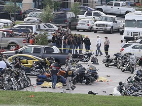 Authorities investigate a shooting in the parking lot of the Twin Peaks restaurant Sunday, May 17, 2015, in Waco, Texas. (AP Photo/Jerry Larson)