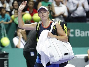 Caroline Wozniacki waves after losing to Elina Svitolina at the WTA tennis finals in Singapore, Thursday, Oct. 25, 2018. (AP Photo/Vincent Thian)