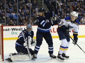 Winnipeg Jets goaltender Connor Hellebuyck and defenceman Ben Chiarot see a shot hit the end boards with St. Louis Blues forward Sammy Blais causing havoc in Winnipeg on Mon., Oct. 22, 2018. Kevin King/Winnipeg Sun/Postmedia Network