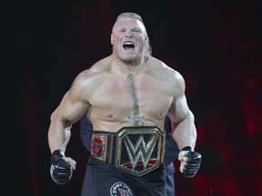 In this March 29, 2015, file photo, Brock Lesnar makes his entrance at Wrestlemania XXXI in Santa Clara, Calif.