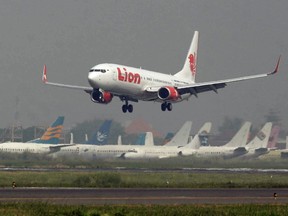 In this May 12, 2012 file photo, a Lion Air passenger jet takes off from Juanda International Airport in Surabaya, Indonesia.