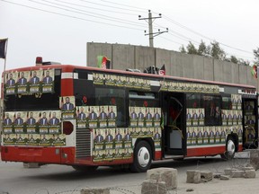A campaign bus is covered with posters of parliamentary candidate, Dr. Abdul Baqi Ameen, ahead of Parliamentary elections scheduled for Oct. 20, during a campaign rally in Kabul, Afghanistan, Tuesday, Oct. 16, 2018.