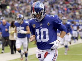 In this Oct. 28, 2018, file photo, New York Giants quarterback Eli Manning (10) runs off the field at the end of the first half of the team's NFL football game against the Washington Redskins in East Rutherford, N.J. (AP Photo/Bill Kostroun, File)
