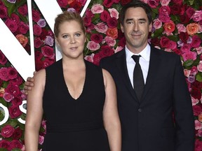 FILE - In this June 10, 2018 file photo, Amy Schumer, left, and Chris Fischer arrive at the 72nd annual Tony Awards in New York.  Schumer announced she's pregnant with husband Fischer. She broke her baby news Monday on the Instagram stories of friend and journalist Jessica Yellin.