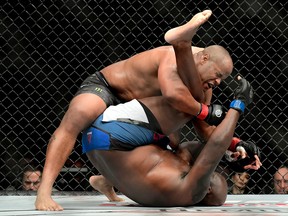 Daniel Cormier (top) fights against Derrick Lewis in their heavyweight title bout during the UFC 230 event at Madison Square Garden on Nov. 3, 2018 in New York City.  (Steven Ryan/Getty Images)