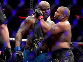 Daniel Cormier, right, talks with Derrick Lewis after defeating him by submission in their heavyweight title bout during the UFC 230 event at Madison Square Garden on Nov. 3, 2018 in New York City. (Steven Ryan/Getty Images)