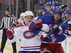 Canadiens' Max Domi battles Rangers' Marc Staal along the boards at Madison Square Garden in New York on Tuesday night.