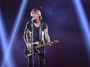 Keith Urban performs "Never Comin' Down" at the 52nd annual CMA Awards at Bridgestone Arena on Wednesday, Nov. 14, 2018, in Nashville, Tenn.