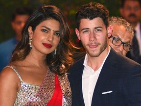 (FILES) In this file photo taken on June 28, 2018, Indian Bollywood actress Priyanka Chopra (L) accompanied by Nick Jonas arrive for the pre-engagement party of India's richest man and Reliance Industries Limited Chairman, Mukesh Ambanis eldest son Akash Ambani and fiancee Shloka Mehta in Mumbai. - American singer Nick Jonas on August 18 announced Indian superstar Priyanka Chopra will be "Mrs Jonas" after the couple performed a traditional ceremony in Mumbai, the home of Bollywood cinema.