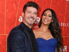 US singer/songwriter Robin Thicke and partner Mexican model April Love Geary arrives at the amfAR Gala Los Angeles at the Wallis Annenberg Center for the Performing Arts on October 18, 2018 in Beverly Hills.