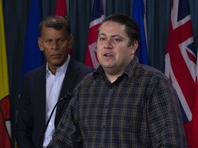 Canadian Labour Congress President Hassan Yussuff looks on as Canadian Union of Postal Workers President Mike Palecek speaks during a news conference on Parliament Hill Friday November 23, 2018 in Ottawa.