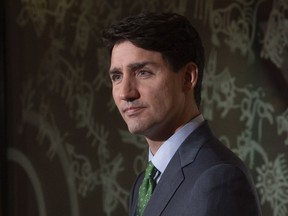 Prime Minister Justin Trudeau listens to a question during a media availability in Paris, France, Monday, Nov. 12, 2018.