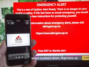 A smartphone and a television receive visual and audio alerts to test Alert Ready, a national public alert system in Montreal on May 7, 2018.