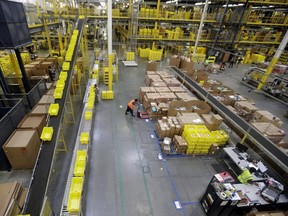 In this Aug. 1, 2017, file photo, employees work at the Amazon Fulfillment centre in Robbinsville Township, N.J.