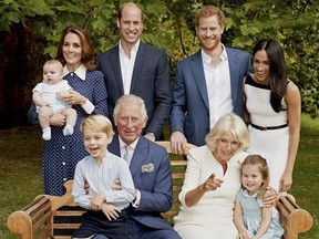 In this handout image provided by Clarence House and taken on Sept. 5, 2018, Britain's Prince Charles poses for an official portrait to mark his 70th Birthday in the gardens of Clarence House, with Camilla, Duchess of Cornwall, Prince William, Kate, Duchess of Cambridge, Prince George, Princess Charlotte, Prince Louis, Prince Harry and Meghan, Duchess of Sussex, in London, England.