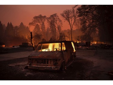 Flames burn inside a van as the Camp Fire tears through Paradise, Calif., on Thursday, Nov. 8, 2018.