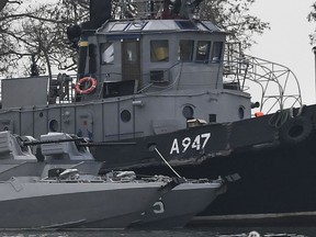 The damage on one of three Ukrainian ships is seen docked after been seized ate Sunday, Nov. 25, 2018, in Kerch, Crimea, Monday, Nov. 26, 2018. The Ukrainian parliament is set to consider a presidential request for the introduction of martial law in Ukraine following an incident in which Russian coast guard ships fired on Ukrainian navy vessels. (AP Photo)