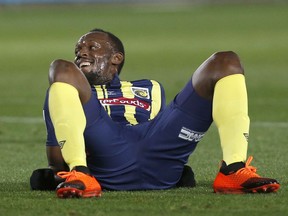 In this Aug. 31, 2018, file photo Usain Bolt lies on the pitch after taking a shot at goal during a friendly trial soccer match between the Central Coast Mariners and the Central Coast Select in Gosford, Australia.