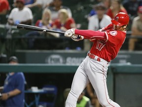 In this Sept. 5, 2018, file photo, Los Angeles Angels' Shohei Ohtani follows through on a two-run home run against the Texas Rangers during the eighth inning of a baseball game in Arlington, Texas.