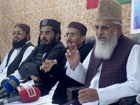 Mohammed Ahmed Ludhianvi, right, chief of Ahle Sunnat Wal Jammat, a Pakistani radical Islamist party, addresses a news conference where he condemned  the Supreme Court decision that acquitted Asia Bibi, a Christian woman, who spent eight years on death row accused of blasphemy, in Islamabad, Pakistan, Monday, Nov. 5, 2018.