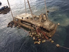 In this photo taken and released by the Thailand Phuket Public Affairs Office, Saturday, Nov. 17, 2018, the tour boat named the Pheonix is raised from the sea floor after sinking over four months ago in rough weather killing 47 tourists.