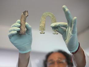 Jedu Sadarnaga shows jewelry on Thursday, Nov. 15, 2018 from one of the tombs found at a Bolivian quarry near the capital of La Paz. The tombs contained remains belonging to more than 100 individuals and were buried with more than 30 vessels used by the Incas.