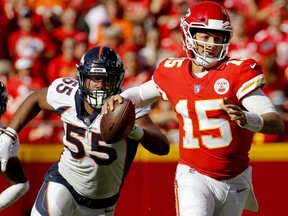 In this Sunday, Oct. 28, 2018, file photo, Kansas City Chiefs quarterback Patrick Mahomes (15) is pursued by Denver Broncos linebacker Bradley Chubb (55) during the second half of an NFL football game in Kansas City, Mo.