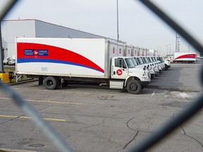 Idle Canada Post trucks sit in the parking lot of the Saint-Laurent sorting facility in Montreal as rotating strikes hit the area on Thursday November 15, 2018. (THE CANADIAN PRESS/Ryan Remiorz)