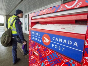Canada Post workers return to work in Montreal after the government ordered them to end their rotating strike Tuesday, Nov. 27, 2018.