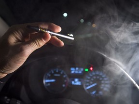 In this photo illustration, smoke from a cannabis oil vaporizer is seen as the driver is behind the wheel of a car in North Vancouver, B.C. Wednesday, Nov. 14, 2018. Canadian police have not seen a spike in cannabis-impaired driving one month since legalization, but there needs to be more awareness of laws around storing marijuana in vehicles and passengers smoking weed, law enforcement officials say.