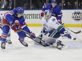 Vancouver Canucks goaltender Jacob Markstrom stops a shot by the Rangers' Filip Chytil.